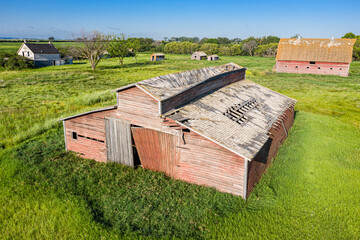 A barn with a large roof and a small door