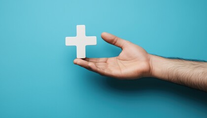 Obraz premium Male Hand Holding Plus Sign Against Blue Background: Symbolic Representation Of Virtual Means To Provide Benefits And Positive Outcomes.