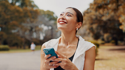 Smile, woman and thinking with phone of fitness outdoor, communication and research of exercise application. Happy, athlete and mobile for gym membership, training schedule and sport routine in Japan