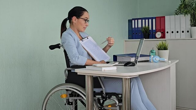 Young disable female teacher consulting online student