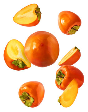 Fresh ripe Persimone fruit falling in the air isolated on white background, food levitation or zero gravity conception