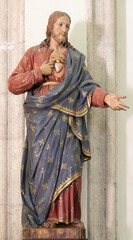 ANNECY, FRANCE - JULY 10, 2022: The carved statue of Heart of Jesus in the St. Maurice church by unknown artist. 