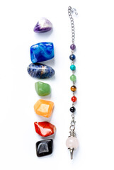 Pendulum made of natural stones (rose quartz) and semi-precious stones in chakra colors.
