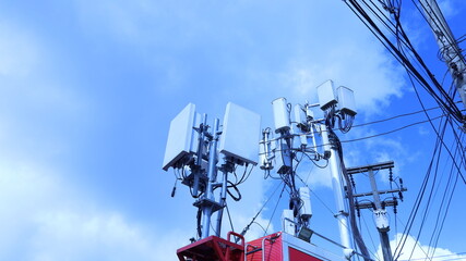 Substation on the roof of the car. 4G and 5G telecommunication equipment mounted on car roof with power transmission lines on pole on sky background with copy space and selective focus