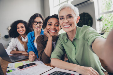 Photo of four diverse women businessladies community take selfie photo modern office room interior workspace