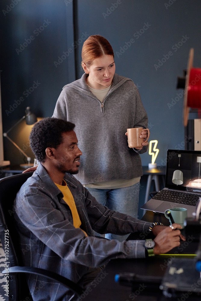 Poster multiracial colleagues collaborating on project in cozy office space with modern equipment, engaging