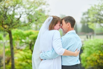 An adult bride and groom . Husband and wife's wedding anniversary photo shoot. We've been together for 30 years.