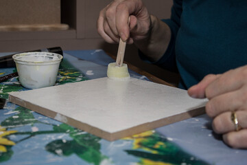 Creative process of painting on a blank canvas in a cozy workspace