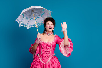 Elegant woman in a pink corset dress waving against a blue background, evoking baroque fashion and...