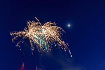 Celebratory fireworks display lights up the night sky during a festive occasion in a vibrant city...