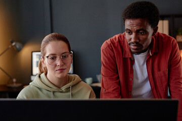 Young female and male colleagues collaborating on project at modern office Two coworkers focused on...