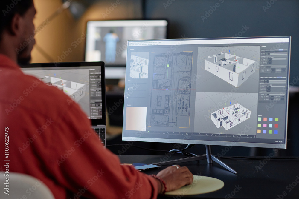 Fototapete Man working on architectural designs on dual computer screens in an office environment. Concentrating on details of building layout and structure on screen