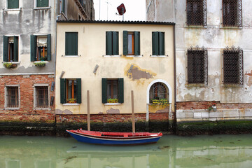 A boat is moored next to a typical old house.