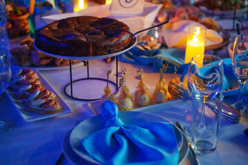 A pie and safe electronic candle on the banquet table. decor for a festive dinner.