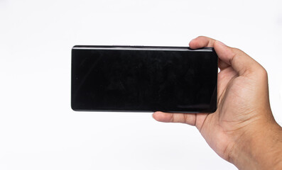 Asian man holds a smartphone with an empty black screen on a white background