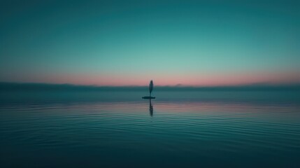 Fototapeta premium Solitary Tree Silhouette On Calm Water At Sunset