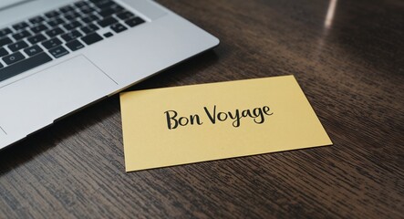bon voyage word written on a business card on table