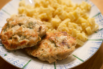 Fototapeta premium Indulgent and Delicious Chicken Patties Accompanied by a Flavorful Pasta Side Dish