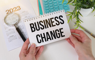 Business Change text on notepad against the background of financial calculations