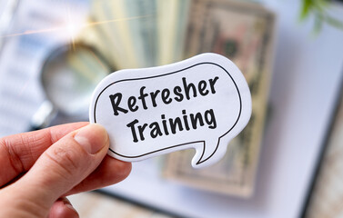 Refresher Training text on paper in hand. Business Education