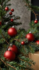 Fototapeta premium Minimalist festive decor with pine branches and red balls.