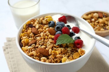 Delicious granola with berries and yogurt on the table