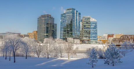 Fototapeta premium Part of Saskatoon Downtown with Victoria Bridge and River Landing Towers on a Winter, Frosty Day