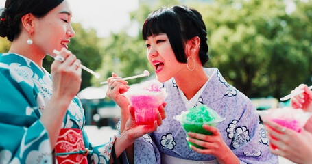 Obraz premium Kimono, sharing and slushy with Japanese women outdoor in city together for bonding as friends. Conversation, kakigori and ice with people eating at festival for culture, heritage or tradition