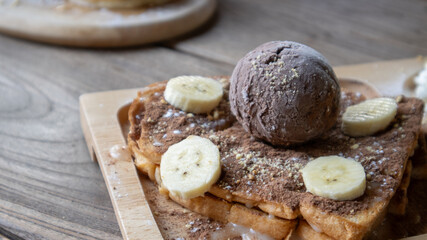 Banana split ice cream.A dessert with chocolate and banana.chocolate dessert on wooden plate