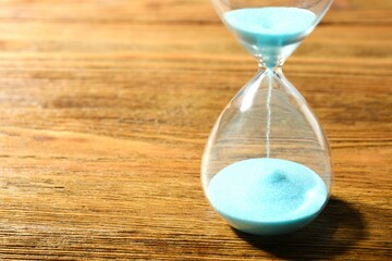 Modern hourglass on the table. Hourglass time concept for business deadline, urgency and outcome of...
