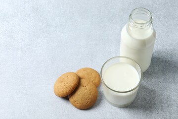 Glass of milk with cookies on the table