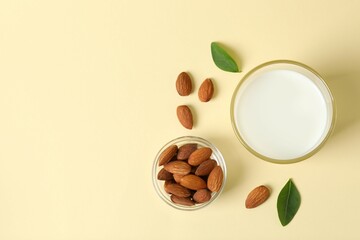 Glass of almond milk on color background