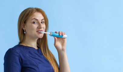 The dentist shows you how to brush your teeth with an electric brush. Banner for medicine and dentistry