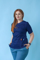 The nurse is wearing a blue medical suit and has toothbrushes in her pocket. creativity in dentistry