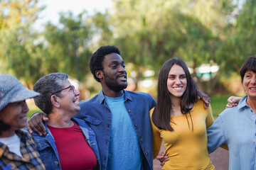 Obraz premium Group of happy multiracial people having fun hugging each other - Multi generational friendship - Community and social inclusion concept
