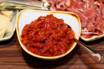 A bowl of red sauce, closeup, spices, and hot chili pepper. 