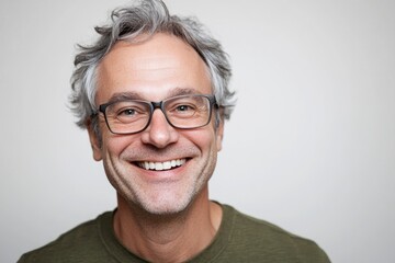 Fototapeta premium A person wearing glasses smiles directly into the camera lens