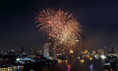 High angle view colorful fireworks over Chao Phraya River, Bangkok cityscape, festival celebrate, New Year, Christmas, night shot, display showing