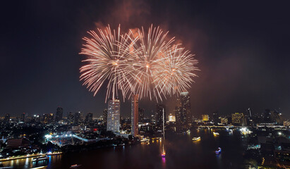 High angle view colorful fireworks over Chao Phraya River, Bangkok cityscape, festival celebrate, New Year, Christmas, night shot, display showing