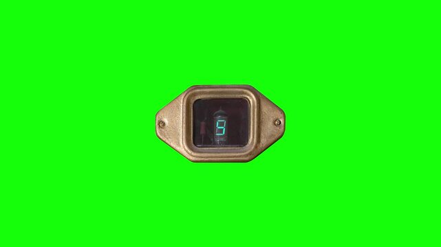 A luminescent old-fashioned indicator with a golden frame counts seconds from 0 to 9, is isolated on green screen.