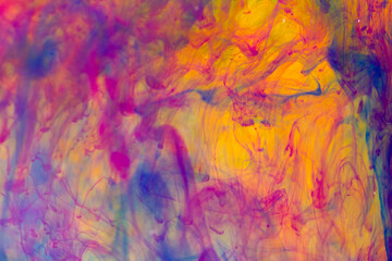 Abstract background creating picturesque structures from streaks of colored ink with a dominant orange background color.