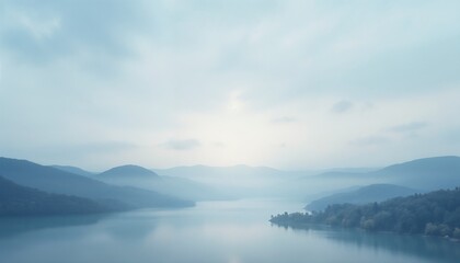 Misty landscape with serene lake and mountains in soft blue tones with copy space