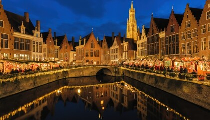 Fototapeta premium Medieval European city at night, Christmas market by the canal with reflections.