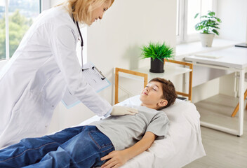 Pediatrician, kids doctor examining child lying couch for heart, lung disease, respiratory...