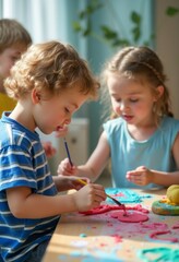 Naklejka premium Two young children, a boy with curly hair and a girl with braided hair, are deeply focused on their colorful art project, surrounded by vibrant play dough and tools. The warm sunlight filters through