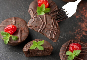 Freshly baked chocolate brownies decorated with sweet cherries and sprigs of mint