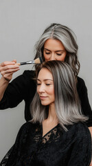 Obraz premium Professional hairstylist applying hair color for a stylish transformation