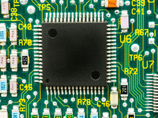 Close-up of microcircuits and components: chips, diodes and capacitors on a printed circuit board,...
