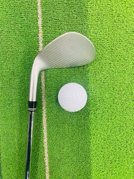 golf club and ball on grass