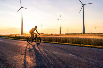 Cyclist on the racing bike at sunset